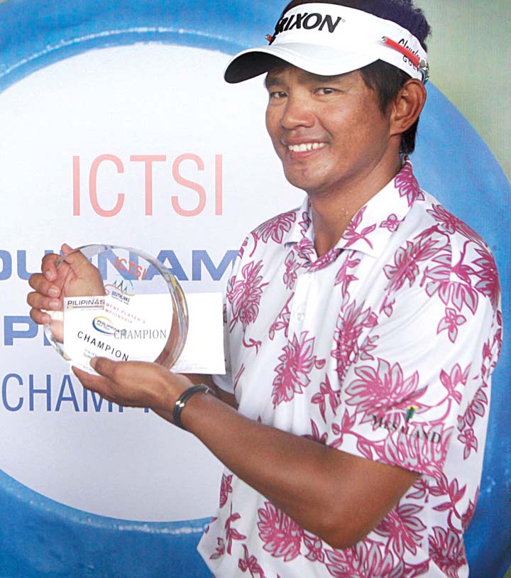 Mars Pucay holds the championship trophy after winning the ICTSI Players Championship at Southlinks Golf Club in Las Piñas yesterday.